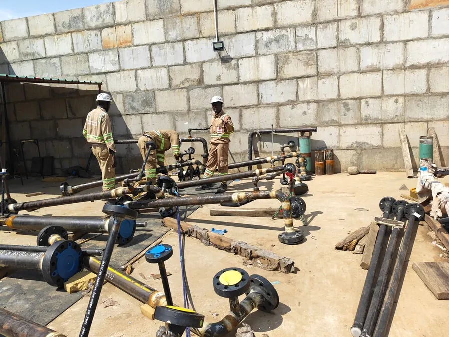 Pipe spools and radiography equipment laid out at the IXAR construction support base compound, Tilenga Project, Uganda